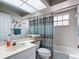 Well-lit bathroom featuring a tub with shower, a window, and vanity at 542 Clubside Cir # 20, Venice, FL 34293