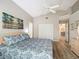 Bright bedroom with vaulted ceilings, ceiling fan, wood floors, and ensuite bathroom at 542 Clubside Cir # 20, Venice, FL 34293
