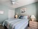 Relaxing bedroom with a ceiling fan, light-blue walls, and ample closet space at 542 Clubside Cir # 20, Venice, FL 34293
