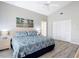 Light and airy bedroom with light wood floors, a ceiling fan and ample closet space at 542 Clubside Cir # 20, Venice, FL 34293