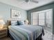 Comfortable bedroom featuring a large bay window and a ceiling fan at 542 Clubside Cir # 20, Venice, FL 34293