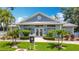 Inviting clubhouse featuring a well-manicured lawn, palm trees, and a welcoming entrance at 542 Clubside Cir # 20, Venice, FL 34293