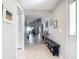 Bright and airy entryway featuring tile flooring, neutral walls, and a view into the living spaces at 542 Clubside Cir # 20, Venice, FL 34293