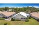 Aerial view of home with manicured lawn and screened porch at 542 Clubside Cir # 20, Venice, FL 34293