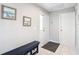 Welcoming foyer with neutral walls, tile flooring, and a decorative bench with storage baskets at 542 Clubside Cir # 20, Venice, FL 34293