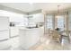 Bright kitchen featuring white cabinets and a cozy breakfast nook with table at 542 Clubside Cir # 20, Venice, FL 34293