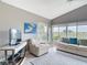 Cozy living room with ample seating and a TV, bathed in natural light and golf course view at 542 Clubside Cir # 20, Venice, FL 34293