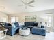Open-concept living room with comfortable blue sectional sofa and views of the outdoor living area at 542 Clubside Cir # 20, Venice, FL 34293