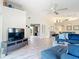Spacious living room featuring vaulted ceilings, beach themed decor and a comfortable blue sectional sofa at 542 Clubside Cir # 20, Venice, FL 34293