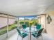 An outdoor patio features a seating area and dining table with views of the golf course at 542 Clubside Cir # 20, Venice, FL 34293