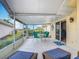 Spacious screened-in patio featuring comfortable seating and views of the surrounding landscaping at 542 Clubside Cir # 20, Venice, FL 34293