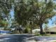 Scenic neighborhood street featuring lush trees, well-maintained lawns, and inviting single-Gathering homes on a sunny day at 542 Clubside Cir # 20, Venice, FL 34293