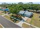 Aerial view of a well-maintained property showcasing mature landscaping and a charming single-story home at 5457 Talbrook Rd, North Port, FL 34287