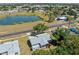 An aerial view shows the property's location near a pond and surrounding neighborhood at 5457 Talbrook Rd, North Port, FL 34287