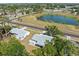 Aerial view of a lakeside residential neighborhood showcasing lush greenery and well-spaced homes at 5457 Talbrook Rd, North Port, FL 34287