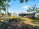 Spacious backyard featuring a screened-in lanai, lush lawn, and additional structure, perfect for outdoor enjoyment at 5457 Talbrook Rd, North Port, FL 34287