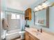 Bathroom featuring a vanity, toilet, bathtub and shower combination, and a large mirror at 5457 Talbrook Rd, North Port, FL 34287