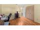 Bright bedroom features hardwood floors, a closet with paneled doors, and a desk at 5457 Talbrook Rd, North Port, FL 34287