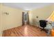 Bedroom features hardwood floors, a window with view, and a desk with chair at 5457 Talbrook Rd, North Port, FL 34287