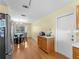 Dining area with wood floors and modern lighting adjacent to kitchen at 5457 Talbrook Rd, North Port, FL 34287