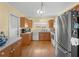 Bright kitchen with wooden cabinets, stainless steel appliances, and natural light at 5457 Talbrook Rd, North Port, FL 34287