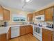 Well-lit kitchen with wooden cabinets and modern appliances at 5457 Talbrook Rd, North Port, FL 34287
