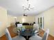 Living room with dining area featuring wood floors and modern lighting at 5457 Talbrook Rd, North Port, FL 34287