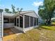 Exterior view of a gray screened porch, and gravel landscaping at 5457 Talbrook Rd, North Port, FL 34287
