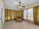 Sunroom with a ceiling fan, carpet, and an upholstered chaise lounge chair at 5457 Talbrook Rd, North Port, FL 34287