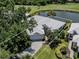 Aerial view of the property, situated on a well-manicured lot with a pond and golf course in the background at 553 Fallbrook Dr, Venice, FL 34292