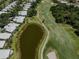 Wide angle aerial view of the home's scenic golf course location and a serene pond at 553 Fallbrook Dr, Venice, FL 34292