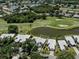 Aerial view of home with golf course and pond in backyard at 553 Fallbrook Dr, Venice, FL 34292
