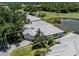 High angle view of the home on a landscaped lot, near a pond and golf course, providing serene views at 553 Fallbrook Dr, Venice, FL 34292