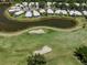 Aerial view showcases this home's location on a lush golf course with a scenic pond nearby at 553 Fallbrook Dr, Venice, FL 34292
