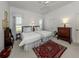 Bright bedroom with two twin beds, soft lighting, and neutral decor at 553 Fallbrook Dr, Venice, FL 34292