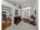 Bright foyer with white walls, wood floors, and a view of the kitchen at 553 Fallbrook Dr, Venice, FL 34292