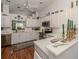 Well-lit kitchen featuring white cabinetry, stainless steel appliances, and a breakfast bar at 553 Fallbrook Dr, Venice, FL 34292