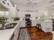 Bright kitchen with white cabinetry, stainless steel appliances, and wood flooring at 553 Fallbrook Dr, Venice, FL 34292