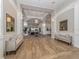 Inviting lobby with wood floors, neutral couches, and elegant wall decor at 553 Fallbrook Dr, Venice, FL 34292