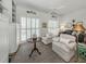 Cozy sitting area with tile flooring, shuttered windows, and views into the living room at 553 Fallbrook Dr, Venice, FL 34292