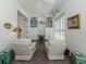 Bright sitting room with two white chairs, built in bookshelves, and decor at 553 Fallbrook Dr, Venice, FL 34292