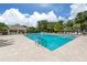 Large swimming pool surrounded by lounge chairs and lush tropical landscaping at 553 Fallbrook Dr, Venice, FL 34292
