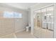 Bathroom featuring a shower, toilet, large mirror, and vanity with dual sinks and white cabinets at 5992 Osprey Rd, Venice, FL 34293