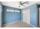 Cozy blue bedroom with a closet and lots of natural light at 5992 Osprey Rd, Venice, FL 34293