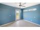 Charming blue bedroom with a fan and a door to the outside at 5992 Osprey Rd, Venice, FL 34293