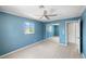 Bedroom with large window, closet and neutral floors with view to another bedroom at 5992 Osprey Rd, Venice, FL 34293