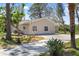 Exterior view of the house with a driveway and mature trees at 5992 Osprey Rd, Venice, FL 34293
