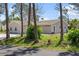 Home exterior with mature trees, driveway and well-maintained lawn at 5992 Osprey Rd, Venice, FL 34293