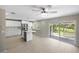 A bright kitchen with white cabinets, island, and stainless steel appliances open to the living area at 5992 Osprey Rd, Venice, FL 34293