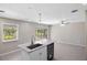 Kitchen island with marble countertops, stainless steel appliances, and an adjacent living area at 5992 Osprey Rd, Venice, FL 34293